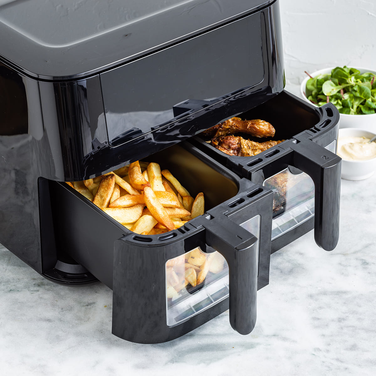 GreenPan Bistro XXL Dual Zone Air Fryer - Black, shown with food or ingredients inside.